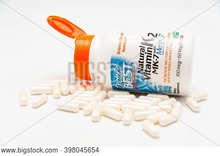 Fuji City, Shizuoka-Ken, Japan - November 7, 2020: Doctors Best, Natural Vitamin K2 MK-7 with MenaQ7, 100 mcg, 60 Veggie Caps. Scattered pills. Isolated on white background. Close-up.