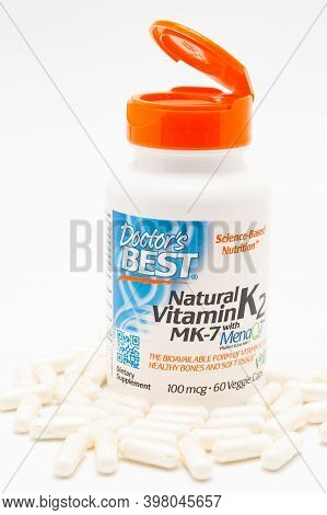 Fuji City, Shizuoka-Ken, Japan - November 7, 2020: Doctors Best, Natural Vitamin K2 MK-7 with MenaQ7, 100 mcg, 60 Veggie Caps. Scattered pills. Isolated on white background. Close-up. Vertical shot.