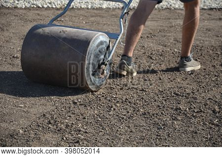 Soil Preparation Before Sowing The Lawn With A Soil Cultivator. Soil Loosening, Raking, Sowing. The 