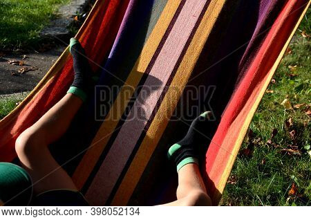 Rocking Chair, Hammock With Wooden Support Among The Trees In The Garden. View Of Naked Hairy White 