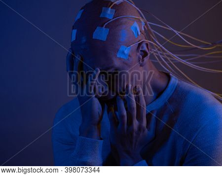 Man With A Bald Head With Wires Connected. Fear And Anxiety. Examination Of The Brain, Mind Control