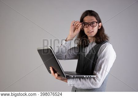 Programming And Writing Code, Developing Software Products. Geek Guy, With Long Hair And Glasses, Ho