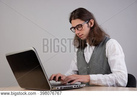 Programming And Application Development, A Young Man Writes Code Sitting At A Laptop. Training In Pr