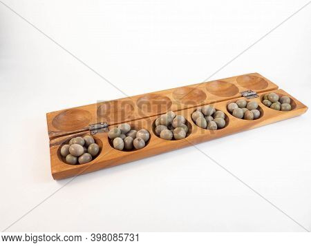 A Traditional African Wooden Game With Seeds, The Awale. Concept Around Play And Tradition.