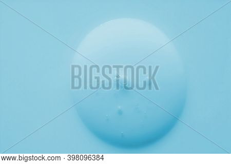 Blurred Blue Cosmetic Liquid Gel Texture With Bubbles Isolated On Blue Background. Liquid Drop Gel T