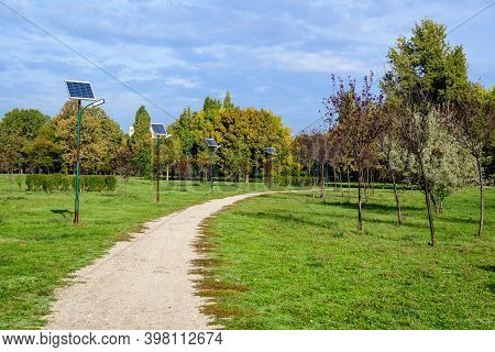 Long Alley And Many Lighting Poles Activated With Attached Blue Solar Panels In Parcul Izvor (izvor 