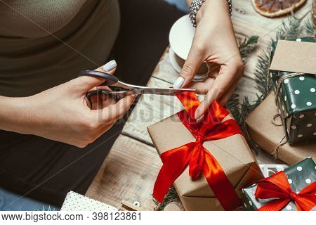 Young Woman Wrapping And Decorates A Lot Of Stack Of Gifts Chri