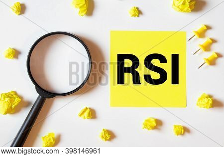 Rsi. The Text Is Written On A Yellow Sheet. The Markers And Sheets Of Paper Are On The Table