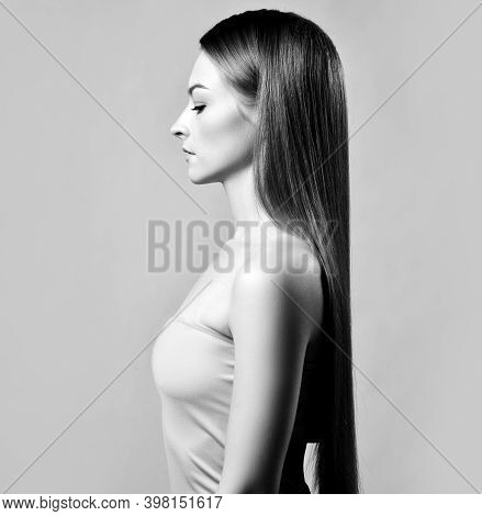 Elegant Profile Of Young Beautiful Woman With Silky Long Straight Hair Standing And Looking Down Ove