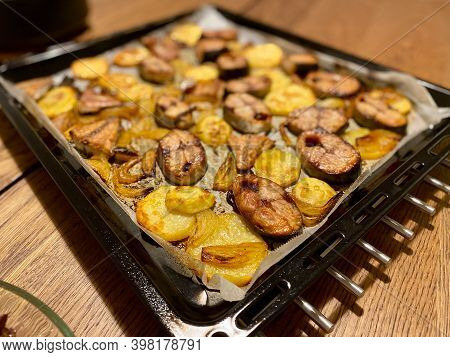 Cooked Bonito Fish Pieces And Potatoes Baked In Oven With Pan. Baking Parchment Paper On Tray. Ready