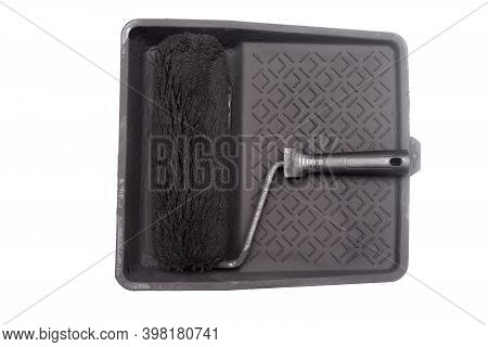 Dirty Paint Roller In Black Color Paint And Painting Cuvette Isolated On The White Background.