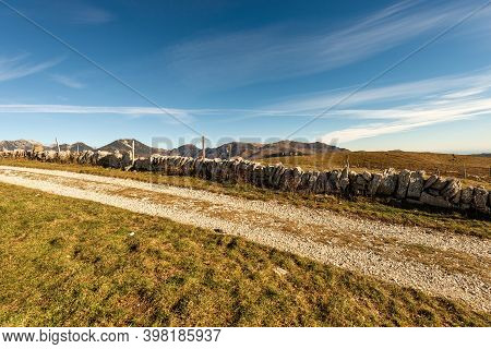 Country Road And Footpath On The Lessinia Plateau (altopiano Della Lessinia) In Autumn, Regional Nat