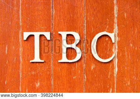 Alphabet Letter In Word  Tbc (abbreviation Of To Be Confirmed Or Continued) On Old Red Color Wood Pl