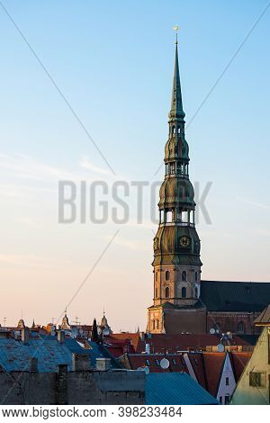 Symbol Of Riga, Old Clock On Medieval Church Tower Among Roofs Ancient Buildings With European Archi