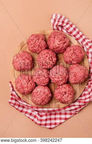 Raw Meatballs On The Wooden Tray Light Brown Background Semifinished Food Vertical