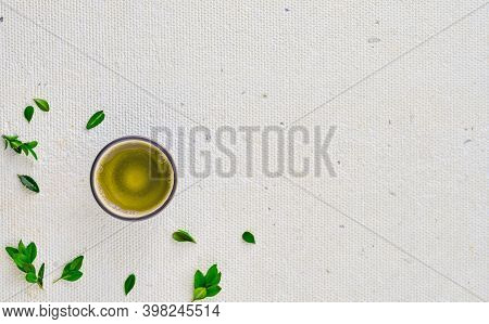 Cup With Green Tea, Next To Green Leaves, Top View With Copy Space. Design Concept, Minimalism