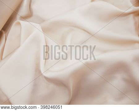 Macro Photography Of Beige Wavy Silk Fabric, As Fashion Wallpaper. Champagne Shade In Satin Fabric W