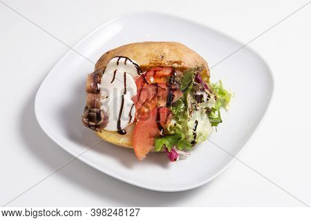Delicious Stuffed Sweet Potato With Cheese, Anchoa, Tomato And Salad Isolated On A White