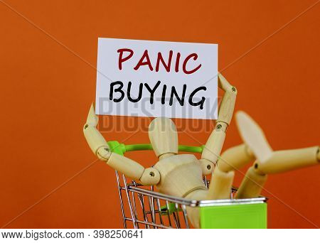 Panic Buying Time. White Sheet Of Paper. Words 'panic Buying'. Wooden Model Of A Human In A Shopping