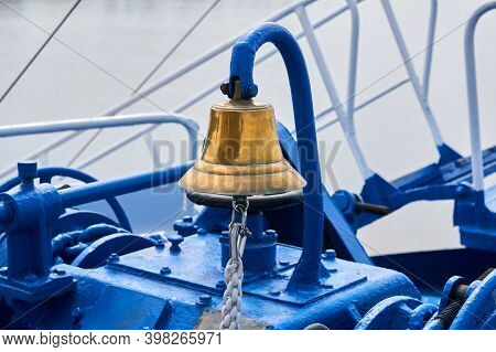 Brass Bell On The Foredeck Of A Ship In Cloudy Light, Close-up