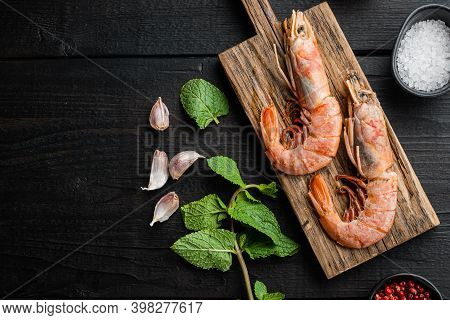 Seafood Scampi On Wooden Board Over Black Wood Table, Flat Lay With Copy Space