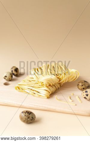 Natural Homemade Noodles With Eggs On A Brown Background. Vertical Orientation. Copy Space.