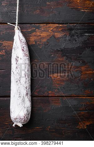 Traditional Spanish Dry Longaniza Sausage On Dark Wood Background With Copy Space