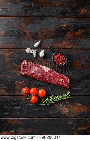 Raw Machete Steak Or Hanger Butcher Steak With Rosemary Over Wood Background Top View