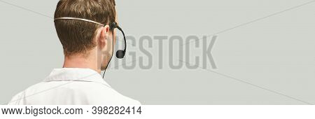 Male Doctor With Headphones. Studio Medicine Portrait. Clinic Online Help. Health Support Call. Tele