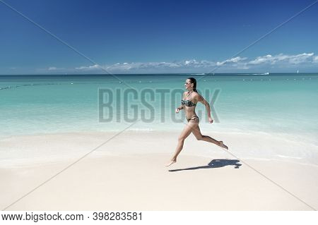 Girl Or Woman In Sexy Bikini Run On Tropical Beach With White Sand, Turquoise Sea Or Ocean Water On 