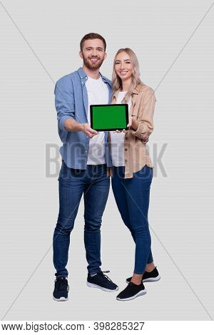 Couple Showing Tablet Green Screen Standing Isolated. Commecial, Shpping, Advertisment Concept