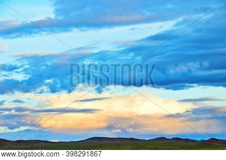 Evening cloudy sky over the sand dunes. Western Mongolia, Mongol-Els desert.