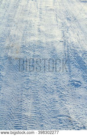 Tire Tracks Left In The Snow On A Bright Sunny Day. The Concept Of Snow Removal, Ski Resorts, Active