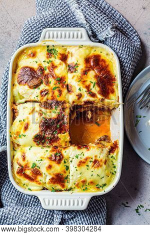 Traditional Greek Potato And Meat Casserole With Cheese - Moussaka, Dark Background. Greek Cuisine C