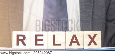 Relax Word On Cube Blocks With Blurred Businessman Suit, Dicrease Stress Concept