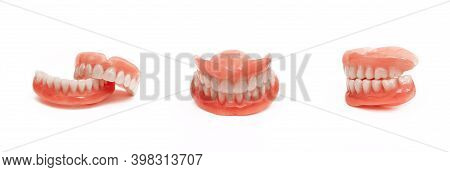 Full Denture Close-up. Dentures. Full Removable Plastic Denture Of The Jaws. Isolate On White Backgr