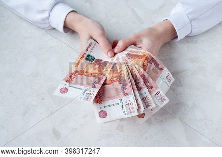 A Lot Of Russian Five-thousand-dollar Bills In Women's Hands, The Concept Of Big Money