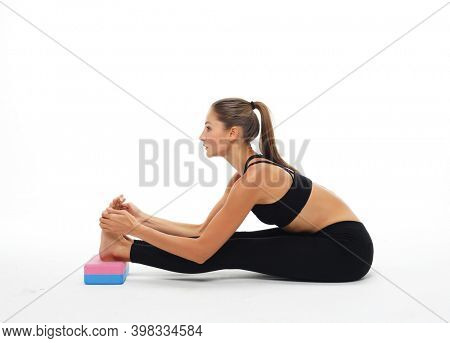 Yoga and fitness concept:Woman practicing yoga with yoga block over white background