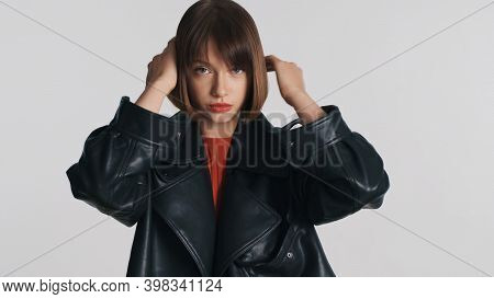 Attractive Stylish Girl Preening Her Haircut Confidently Looking In Camera Over White Background