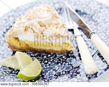 Slice Of Key Lime Pie On Plate Garnished With Lime