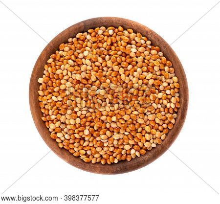 Millet In Wooden Bowl, Isolated On White Background. Unpeeled Millet Seeds. Top View.