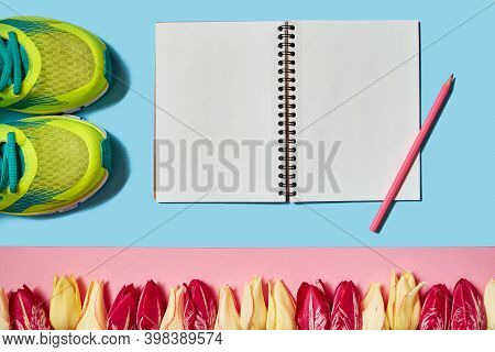 Spring Sport Composition With Running Shoes, Red And Yellow Tulips And Open Blank Notebook On Pink B