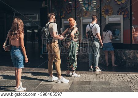 Line To Atm. Group Of People Waiting To Withdraw Money