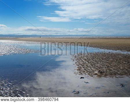 The Beach At Blundell Sands In Sefton Near Near Southport With Water From The Incoming Tide Reflecti