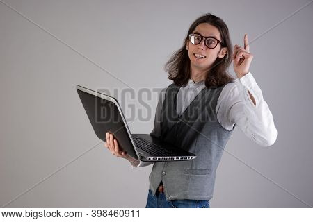 Programming And Writing Code, Developing Software Products. Geek Guy, With Long Hair And Glasses, Ho