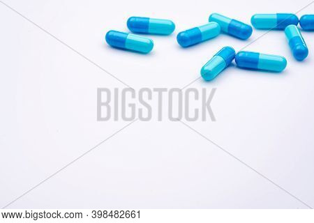 Blue Capsule Pills On White Background. Pharmaceutical Industry. Pharmacy Or Drugstore Products. Hea