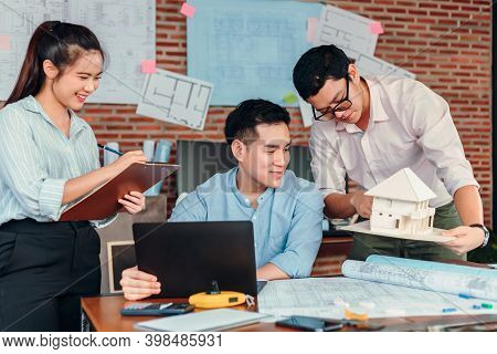Businessman And Architech Meeting For Planing And Checking House Design And House Model And Secretar