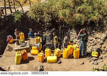 Lalibela, Ethiopia - Feb 14, 2020: People Getting Water At A Water Point In Lalibela, Ethiopia. Afri