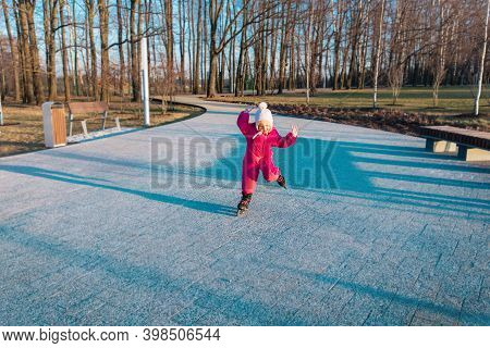 Little Girl Learning Roller Skating Tricks Ourside