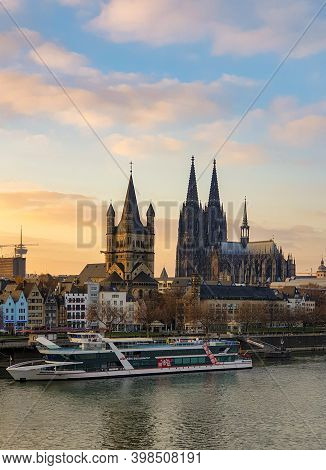 Cologne Germany November 2020, Alongside The Rhein River During Sunset With The Huge Cathedral In Ko